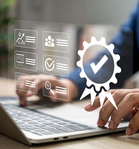 hands typing on laptop with digital quality badge and seven icons representing metrics success and verification